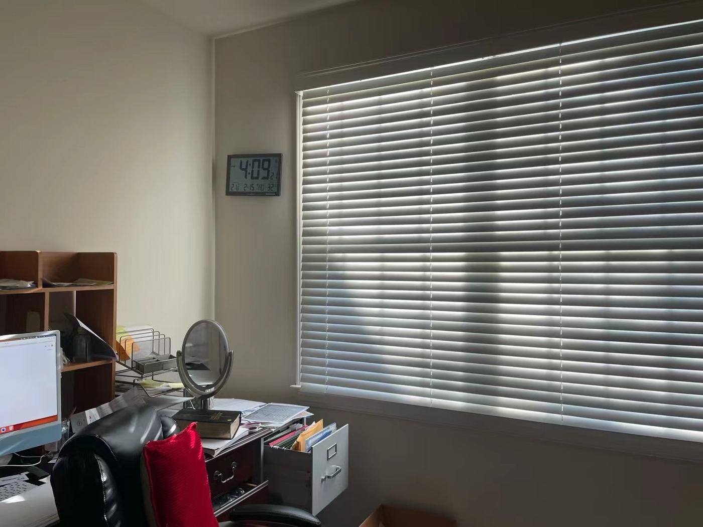 Home office window with bright glare across the desk, before